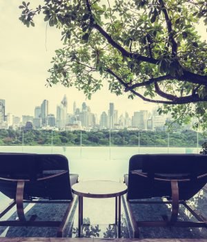 Chair around Outdoor swimming pool with city view - Vintage Filter
